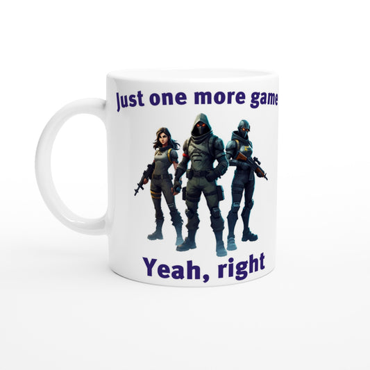 White coffee mug with three characters. The central one is a futuristic, hooded ninja. To his right is a female holding a rifle and long, brown hair.

To his right is a cyborg holding a hunting rifle.

Above them are the words, "Just one more game" written in dark blue.

Beneath them are the words, "Yeah, right" written in dark blue. 